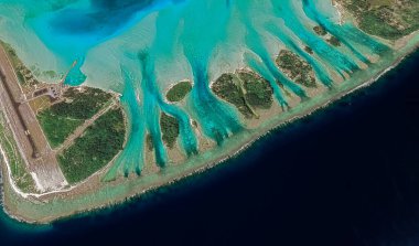 Bora Bora tatil beldesi adasının kıyı manzarası turkuaz su ve kumlu plajlardan kuş bakışı manzaralı.