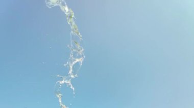 Mavi arka planda bir su sıçramasının yavaş hareketi