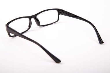 Stylish glasses with black frames on a white background