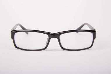 Stylish glasses with black frames on a white background