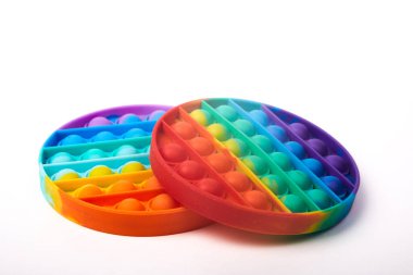 Two children's colorful Pop it toy on a white background