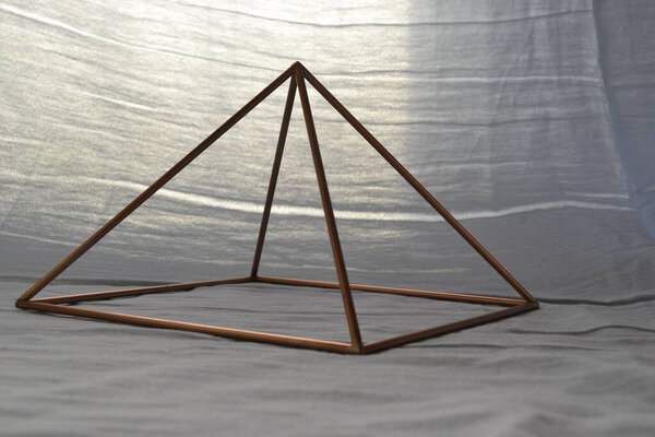 Copper pyramid.  Copper Pyramid  with lighting, white background with natural background lighting, pyramid for home use, Brazil, South America