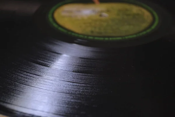 Vinyl record from the 70s photographed, photo in zoom, highlighting the music tracks and apple stamp, with blurred background, Brazil, South America