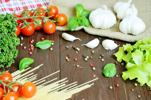 Tomates, spaghettis, persil et ail sur table en bois — Photo
