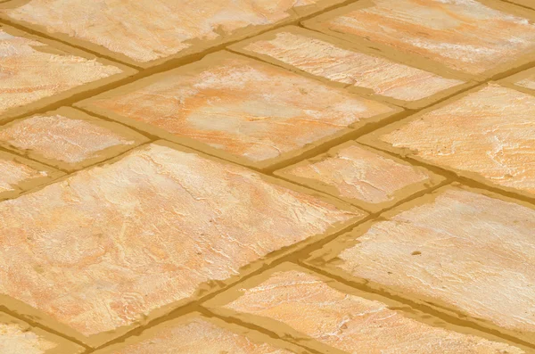 Laying concrete outdoor tiles sandstone colored on the terrace — Stock Photo, Image