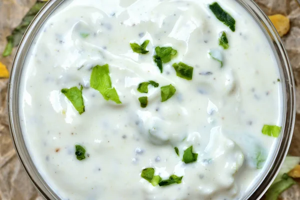 Homemade garlic yogurt dip with herbs. View from top.