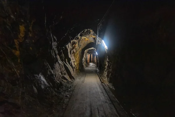 Покинув стару шахту вугілля. Небезпечні тунелі, повні бруду та іржавого обладнання. Металеве та дерев'яне деревообробне обладнання — стокове фото