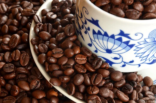 Detail of cup of coffee and pile of coffee beans — Stock Photo, Image