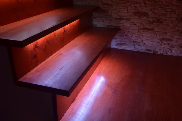 Illuminated wooden stairs — Stock Photo, Image