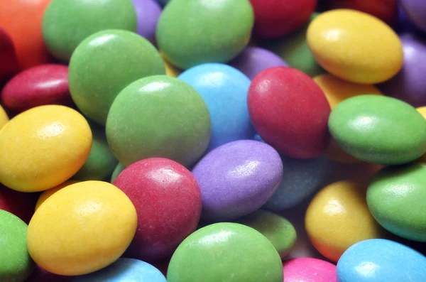 Macro detail of pile of colored smarties — Stock Photo, Image