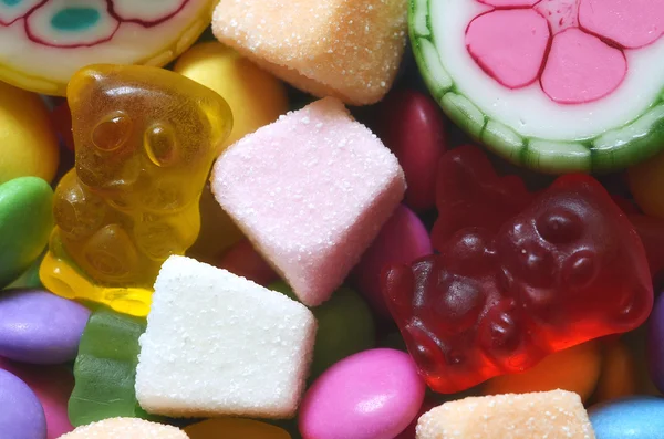 Kyselá jelly růžové, oranžové a bílé candy na barevné lentilky — Stock fotografie