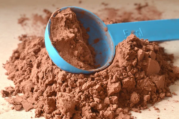 Scoop in brown powder — Stock Photo, Image