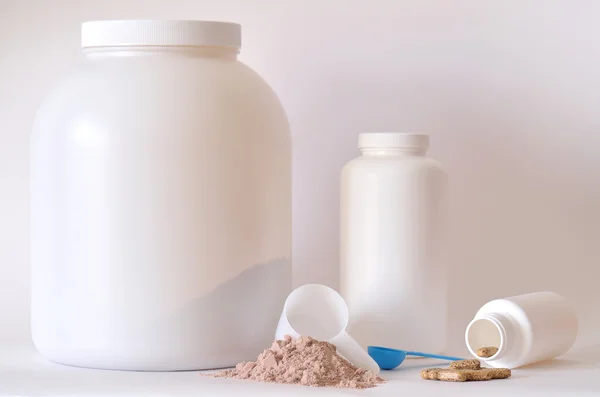 Big jar of protein powder, bottle, pills and tablets — Stock Photo, Image