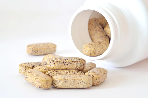 Bottle of multivitamin supplement pills — Stock Photo, Image