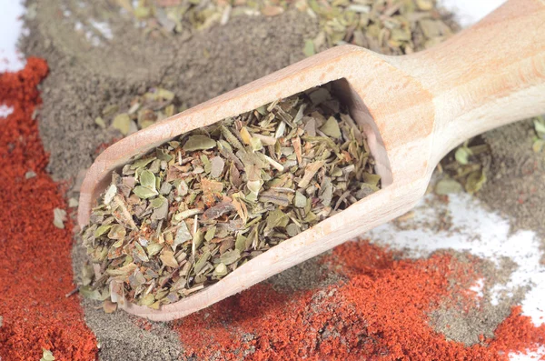 Wooden spoon with the crushed spices - basil and pepper — Stock Photo, Image