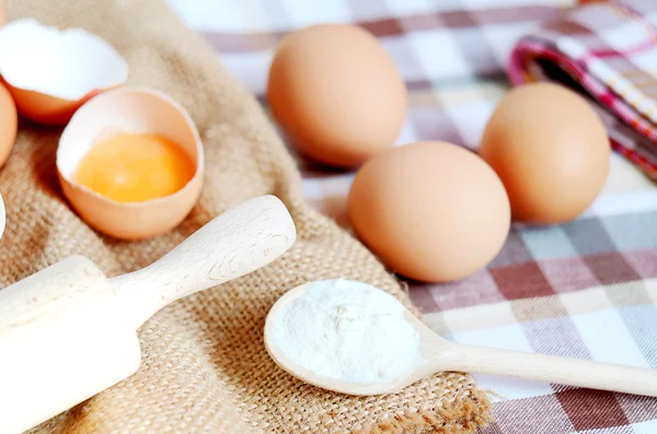 Eggs and raw egg on a linen tablecloth Stock Image