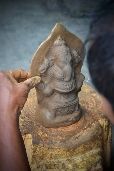 artists making Ganesh/Ganpati idol. eco friendly Ganesh/Ganpati idol or murti, home made eco Friendly Ganesha Idol for Ganapati Pooja. Vinayaka Chaviti
