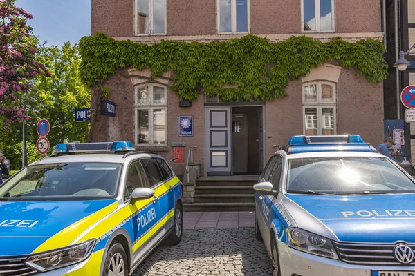 stock image Dannenberg, Germany - May 23, 2019: Two German police cars parking in front of the police station of a medieval city.