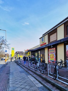 Berlin, Germany - February 20, 2021: Looking down a street in Berlin, Germany, with a supermarket on the right side.