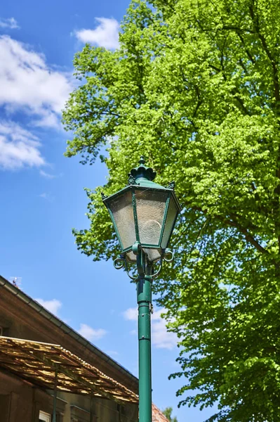 Historic street lamp that was powered by gas and stands in Wuensdorf, Germany.