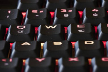 Karanlıkta aydınlatılmış bir bilgisayar klavyesinin parçalarını göster.