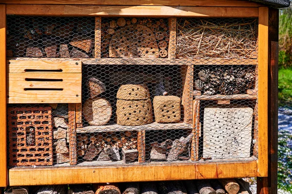 View to an insect hotel made of different materials to offer a retreat for many species.