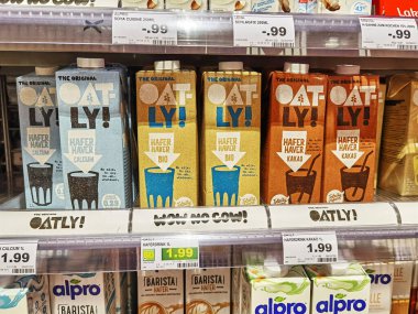 Berlin, Germany - June 10, 2021: View to a shelf with packages of vegan milk beverages in a supermarket.
