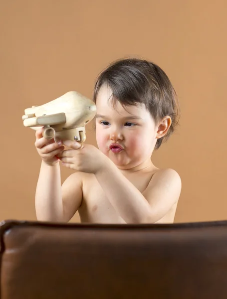 Happy kid playing with toy airplane. Studio shot. — Stock Photo, Image