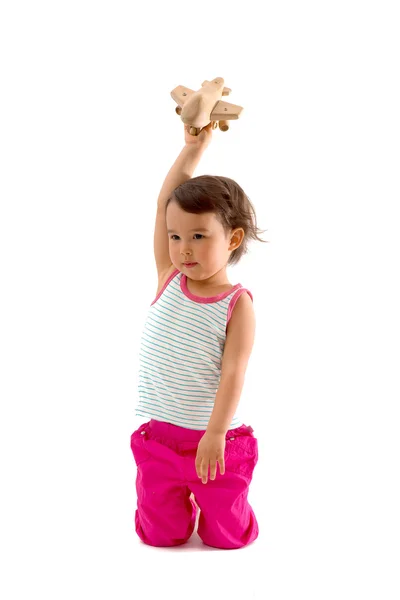 Criança bonita brincando com um avião de brinquedo. Isolado sobre fundo branco — Fotografia de Stock