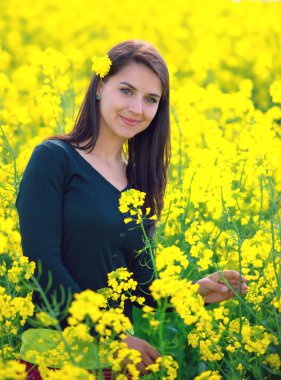portrait of a beautiful girl in the colza field clipart