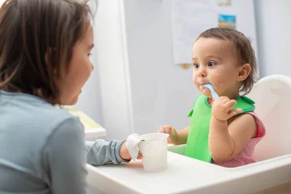 Older Sister Feeding Her Younger Sister Having Fun — Stock Photo, Image