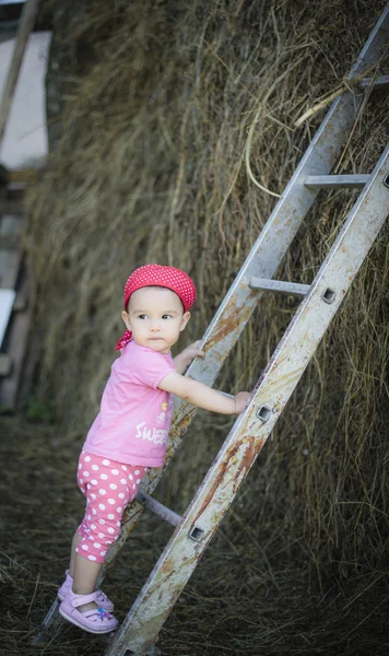 Baby climbing up the ladder — Stock Photo, Image