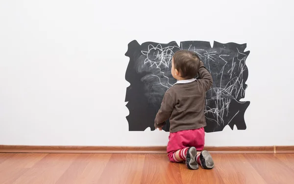 Pequena menina desenho na parede — Fotografia de Stock