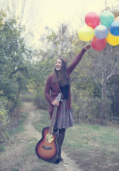 Happy girl with her balloons — Stock Photo, Image