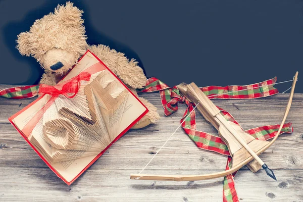 Old bear with vintage old book and bow and arrow — Stock Photo, Image