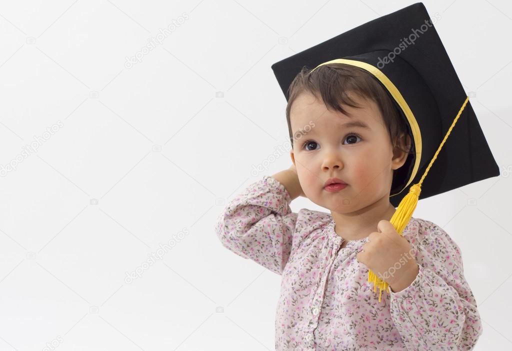 Little girl with graduation hat isolated on white background Stock