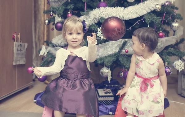 Little girls near the Christmas tree — Stock Photo, Image