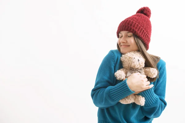 Happy woman hugging a teddy bear — Stock Photo, Image