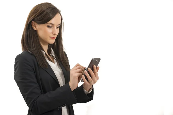 Young businesswoman looks at cellphone — Stock Photo, Image