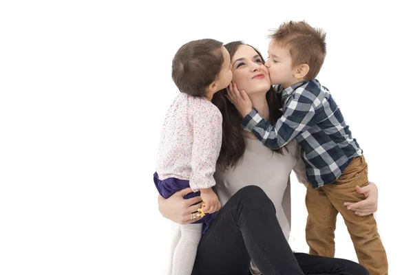 Little girl and boy kissing their mother — Stock Photo, Image