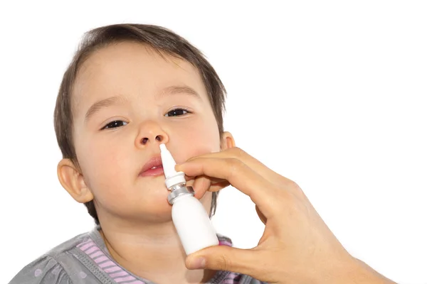 Parent's hand of a sick little girl applies a nasal spray — Stock Photo, Image