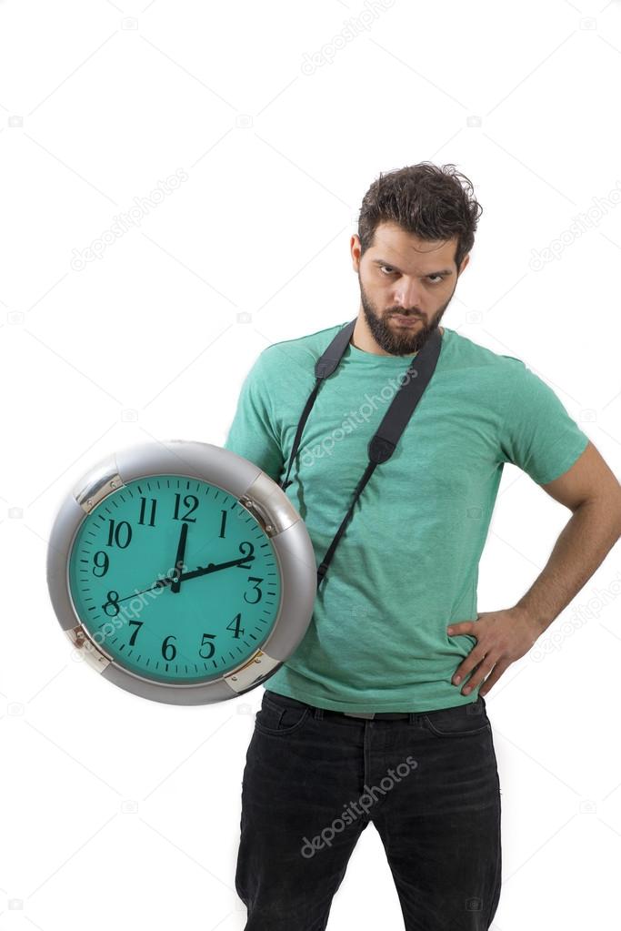 Portrait of an angry male holding big clock running out of time