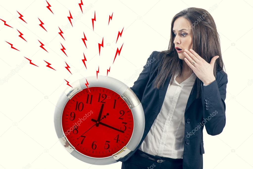 Portrait of a beautiful young woman holding a big clock with red lightening bolt