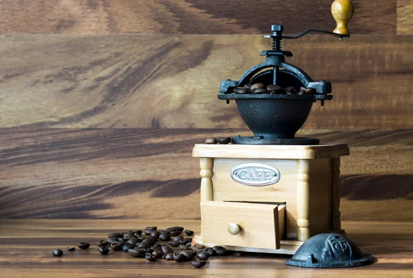 Coffee grinder with coffee beans, isolated — Stock Photo, Image