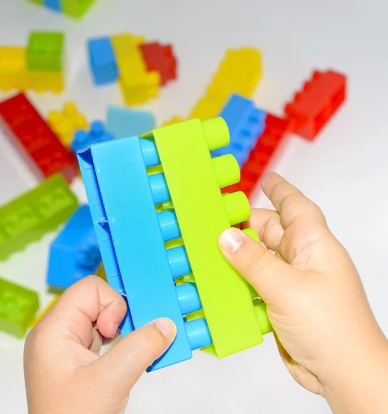 Baby girl playing with colorful blocks on white background — Stock Photo, Image