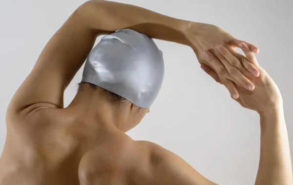 female swimmer's back in studio white background