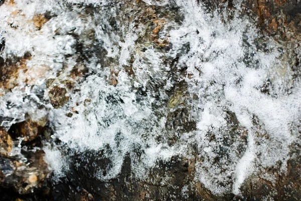 Textura fundo espirrando água e pedras — Fotografia de Stock
