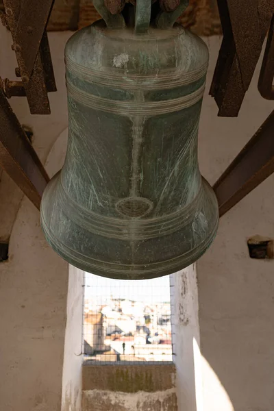 stock image Big iron bell located on the top of one of the main towers of a church at Saint Jorge square, in Caceres, Spain.