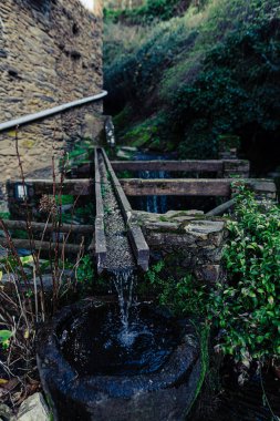 Kayalardan yapılan ve nehirlerden ve doğal kaynaklardan insanların su içtiği küçük köylere su taşımak için kullanılan eski bir borunun detaylı fotoğrafı..