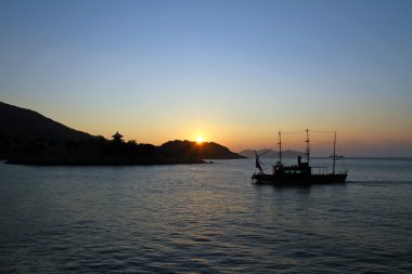 Dawn of islands in Seto inland sea from Tomonoura, Hiroshima, Japan clipart